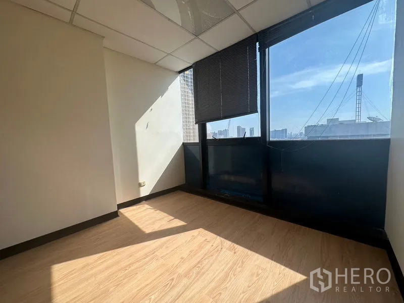 Office Space for rent - Bright corner office with large windows, blinds, city views and warm wood flooring.