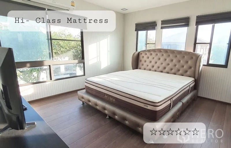 Detached House for rent in Bang Phli, Samut Prakan - Bright master bedroom with large tufted headboard bed, corner windows and wood flooring