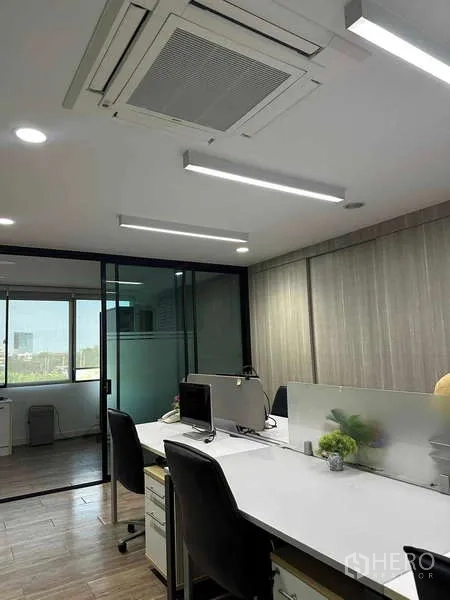 Home Office for rent in Bueng Kum, Bangkok - Open-plan office with workstations, glass meeting room, and LED strip lighting.