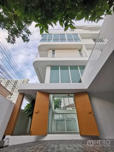 Home Office for sale in Suan Luang, Bangkok - Modern multi-storey home office facade with tall gates and balconies.