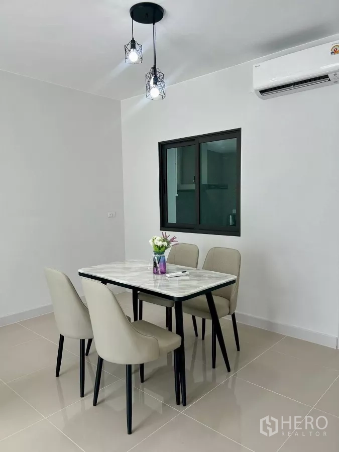 Townhouse for rent in Bang Phli, Samut Prakan - Close view of marble-top dining table with four upholstered chairs.