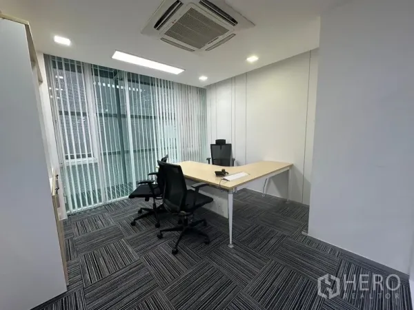 Office Space for rent - Private executive office with L-shaped desk, vertical blinds and carpet tiles.