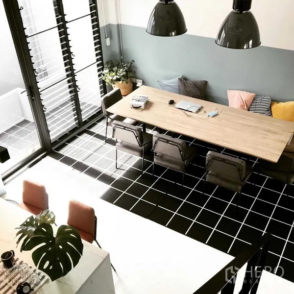 Townhouse for rent or sale in Khlong Toei, Bangkok - Aerial view of dining zone showing black grid tiles and sliding louvered doors.