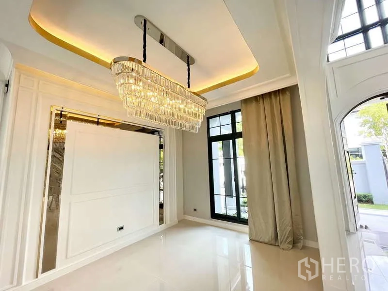 Detached House for sale in Thawi Watthana, Bangkok - Dining area showcasing a contemporary crystal chandelier and tall windows