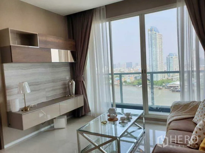 Condominium for rent in Bang Kho Laem, Bangkok - Living room with media wall and balcony overlooking the river.