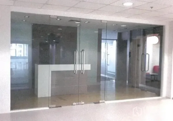 Office Space for rent in Bang Rak, Bangkok - Reception area set behind full-height glass doors with frosted glass panels.