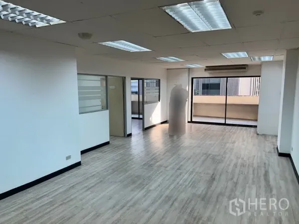 办公空间 出租在Pathum Wan, Bangkok - 明亮的开放式办公室，木纹地板，吊顶灯，落地推拉玻璃门通往阳台。