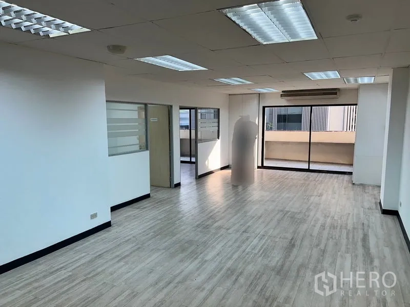 办公空间 出租在Pathum Wan, Bangkok - 明亮的开放式办公室，木纹地板，吊顶灯，落地推拉玻璃门通往阳台。