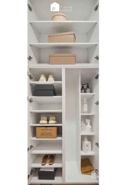 Condominium for sale in Suan Luang, Bangkok - Open shoe storage cabinet with multiple shelves holding shoes and boxes.