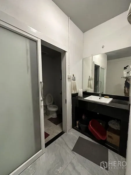 Warehouse for sale in Bang Khen, Bangkok - Washroom area with large countertop sink and sliding door entry.