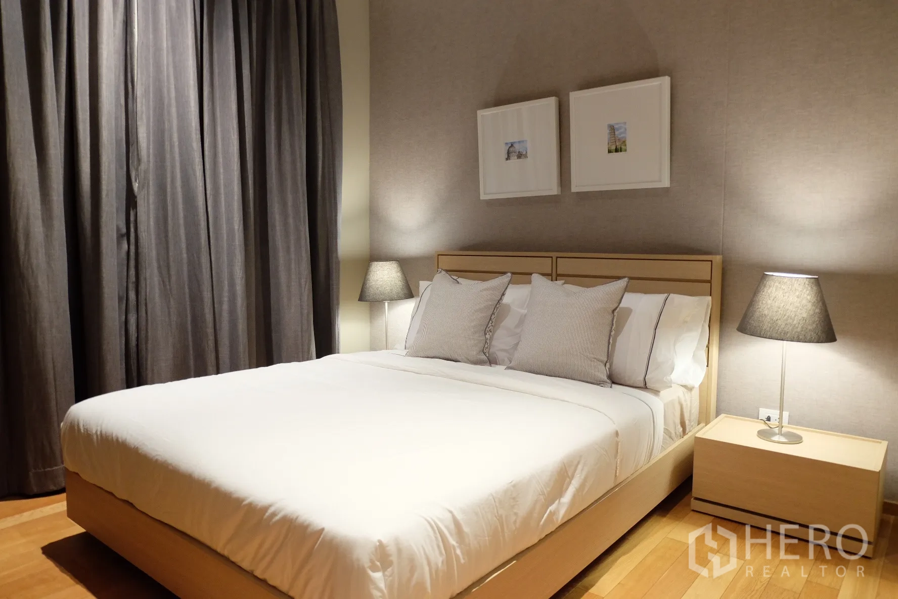 Condominium for rent in Sathon, Bangkok - Second bedroom with light-wood bed, white bedding, grey curtains and matching bedside tables.