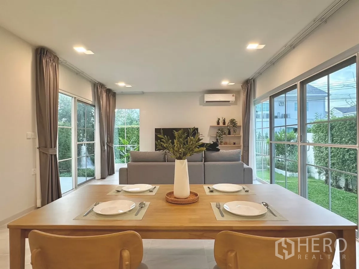 独立式住宅 出租在Bang Phli, Samut Prakan - 采光充足的客餐厅一体空间，推拉落地窗通向花园。