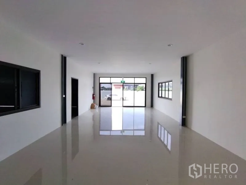 Warehouse for rent in Bang Phli, Samut Prakan - Ground-floor office space with glossy tiled floor and glass front entrance.