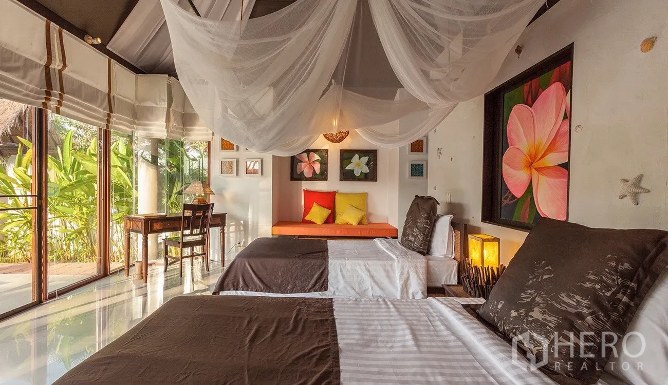 Detached House for sale in Hua Hin, Prachuap Khiri Khan - Guest bedroom with twin beds, writing desk and glass walls facing tropical garden.