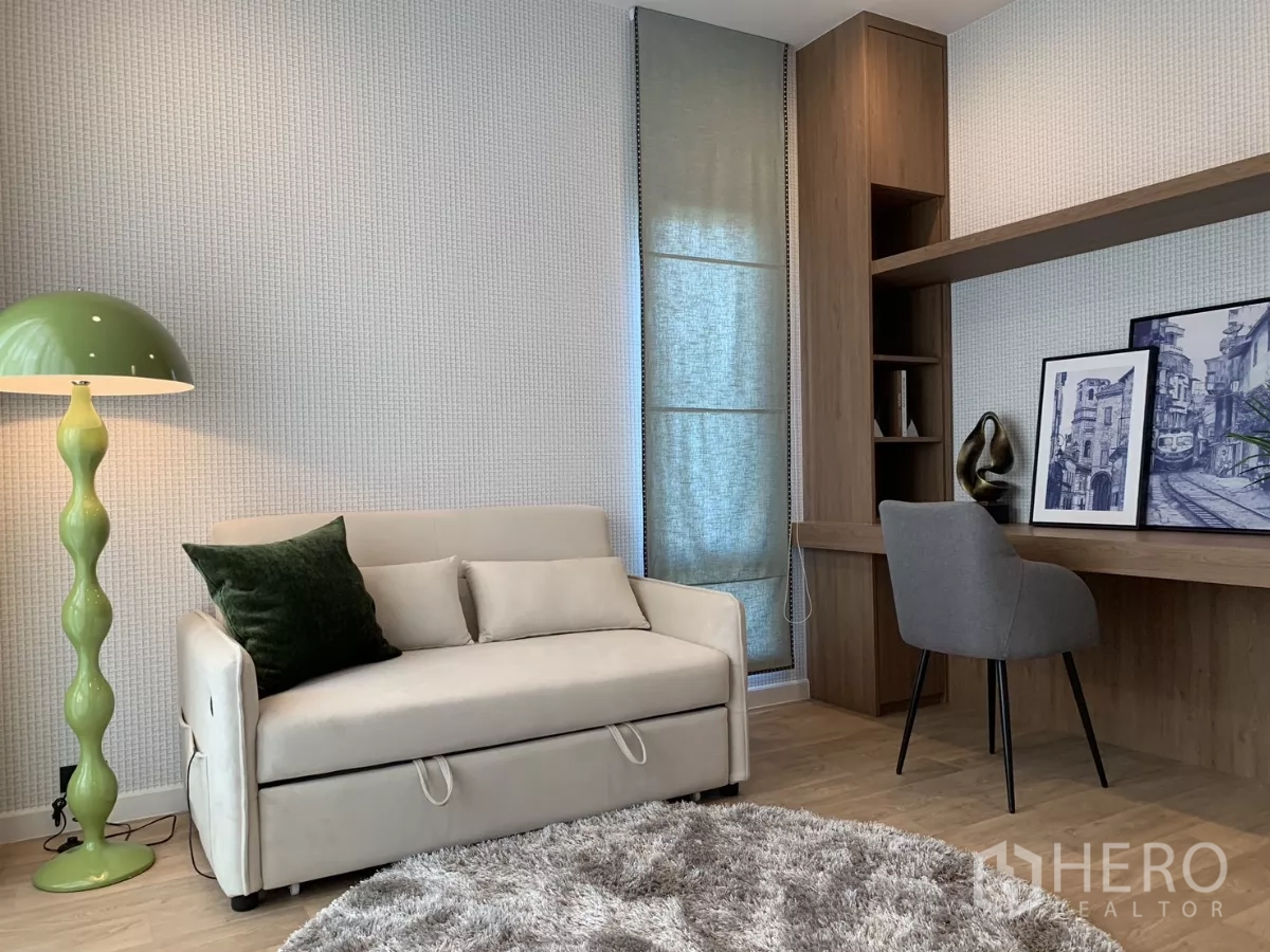 Detached House for rent in Bang Kapi, Bangkok - Multipurpose room with sofa bed, built‑in desk and shelving, wood flooring.