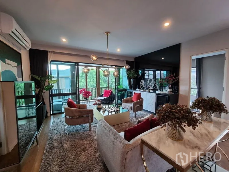 Detached House for rent in Prawet, Bangkok - Upper family lounge opening to a balcony with modern pendant lights and greenery outlook.