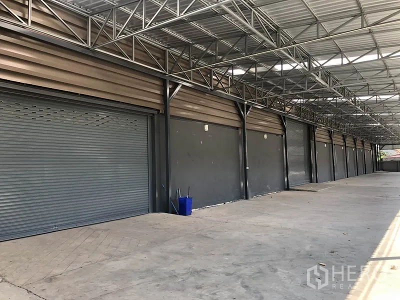工厂 出租或出售在Bang Bo, Samut Prakan - 连续多扇卷帘装卸门，连接有顶平台。