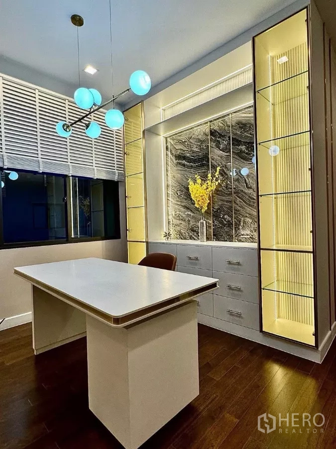 Detached House for sale in Saphan Sung, Bangkok - Home office with modern desk, backlit display shelves and contemporary pendant lights.