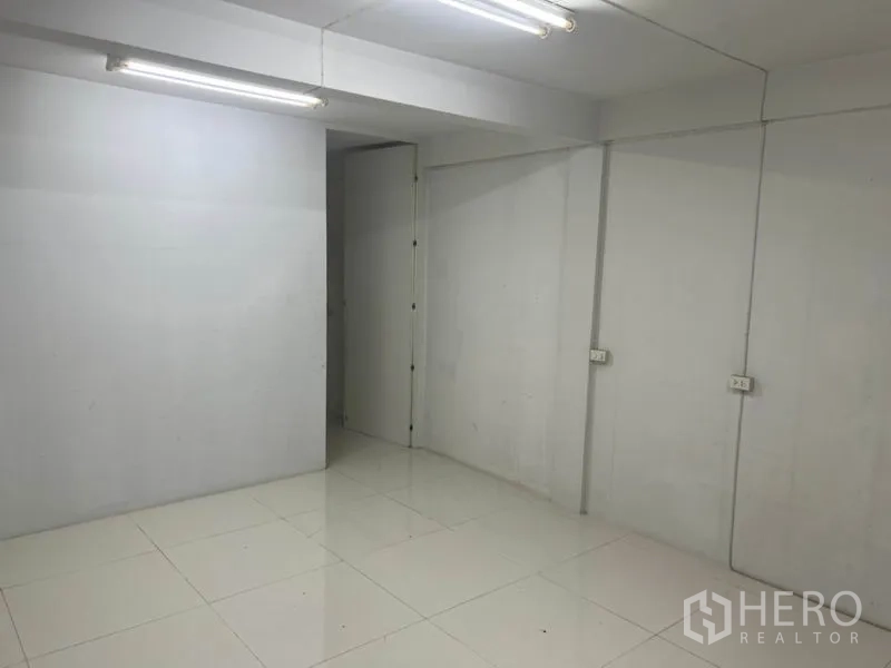 อาคารพาณิชย์ ให้เช่าในBang Rak, Bangkok - ห้องอเนกประสงค์ผนังสีขาว ไฟนีออน และประตูทางเข้า