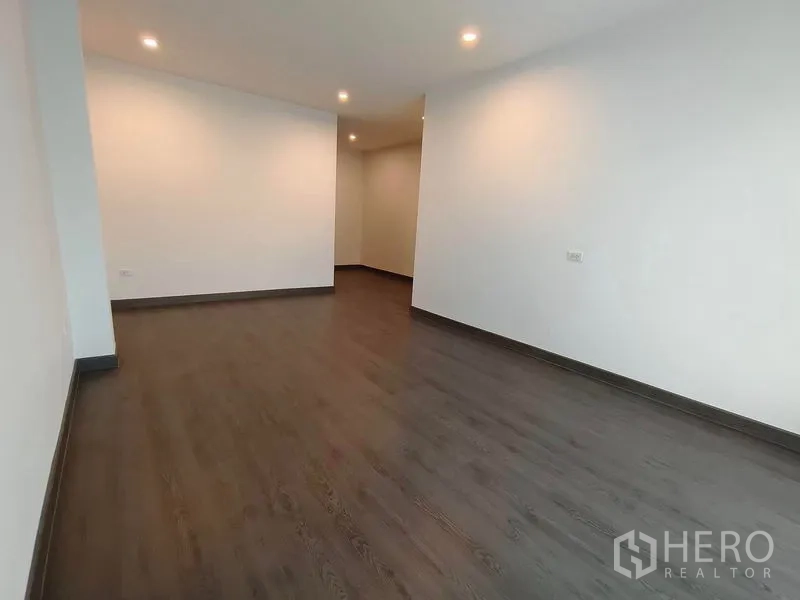 Detached House for rent or sale - Long empty room with dark flooring and downlights, ideal for study or playroom.