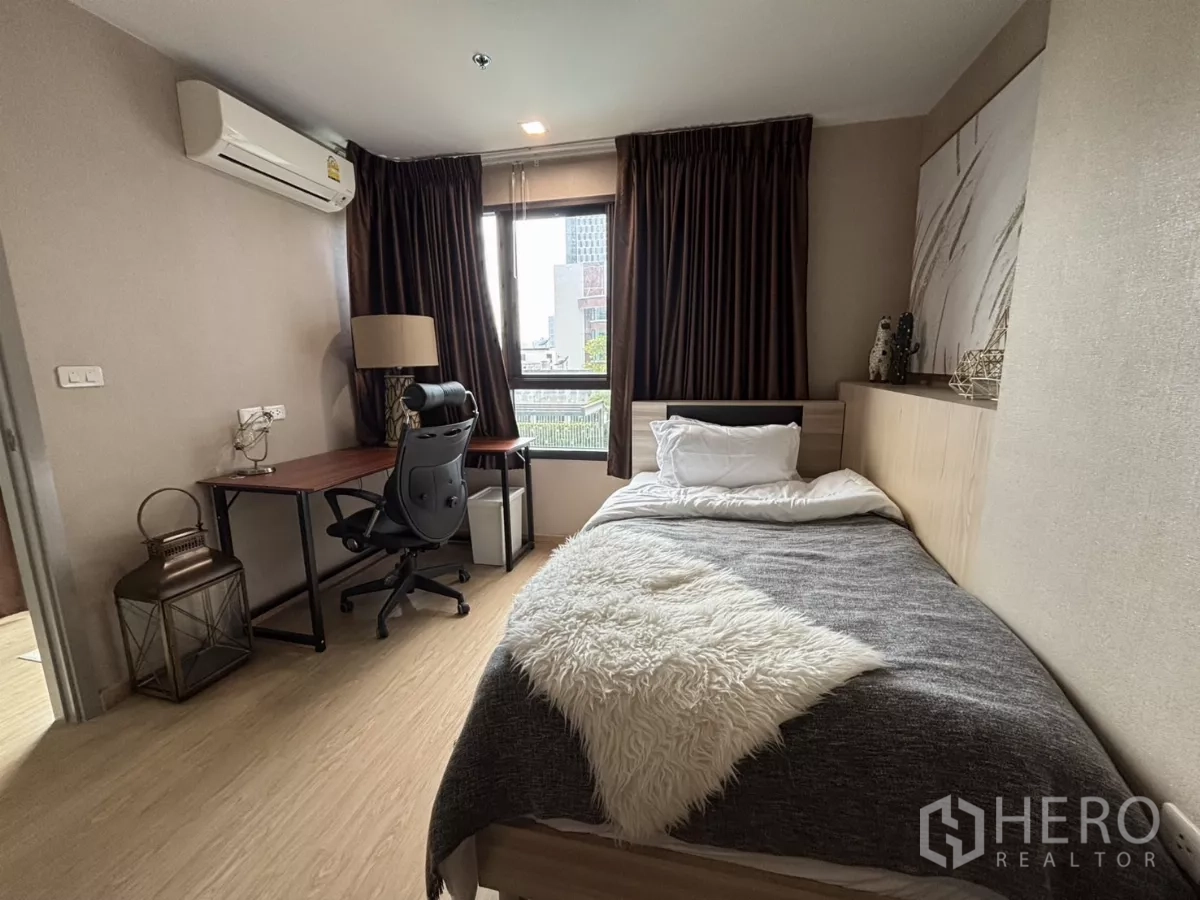 Condominium for rent in Phra Khanong, Bangkok - Third bedroom view showing study desk, task chair and window to greenery.