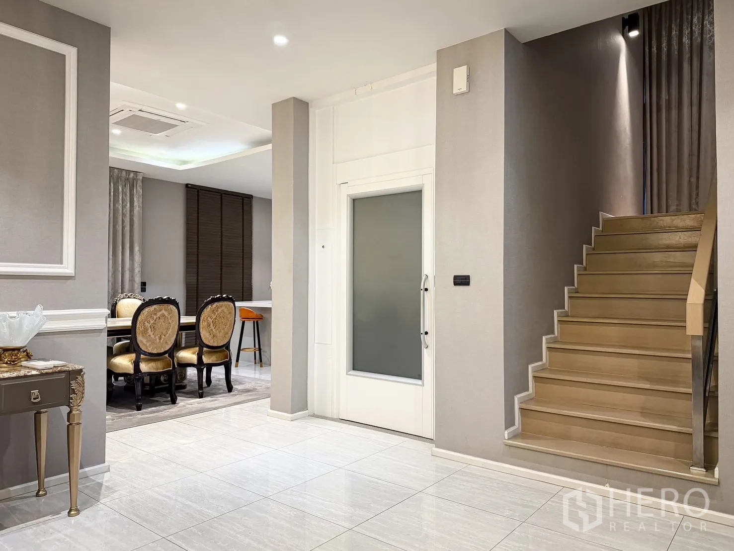 Detached House for rent or sale in Lak Si, Bangkok - Entry hall with tiled floors, staircase, and frosted glass door beside the dining area.