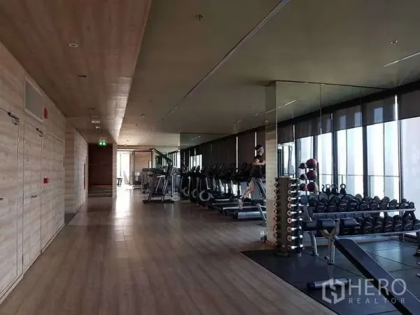 Condominium for rent or sale - Spacious fitness center with treadmills, free weights and mirrored walls overlooking the city.
