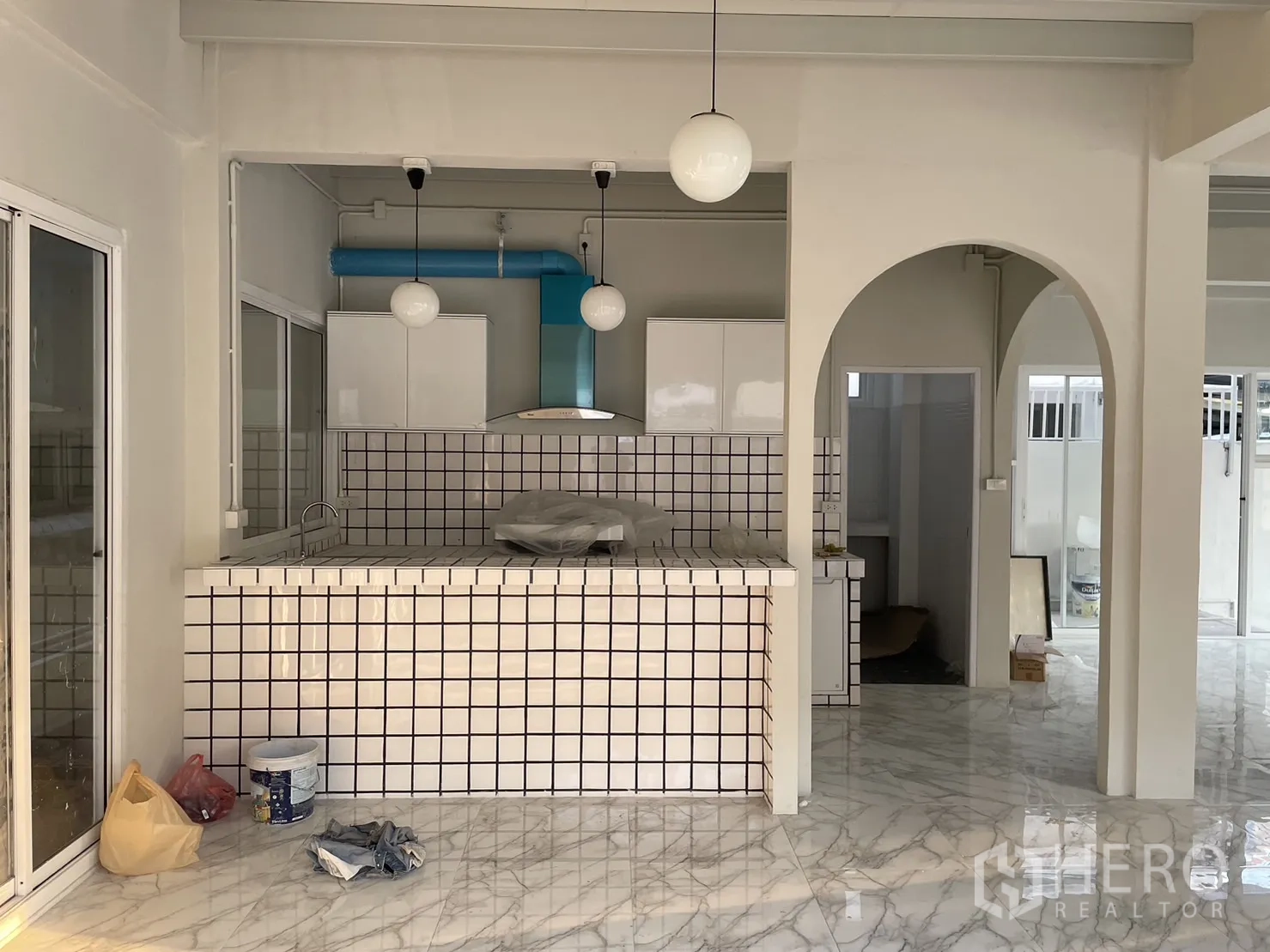 บ้าน ให้เช่าหรือขายในDin Daeng, Bangkok - ครัวเปิด เคาน์เตอร์กรุกระเบื้อง โคมทรงกลมแขวน และท่อระบายสีฟ้า