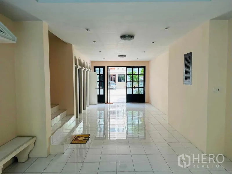 Home Office for rent - Ground-floor foyer or showroom with glossy white tiles and double glass doors to the street.