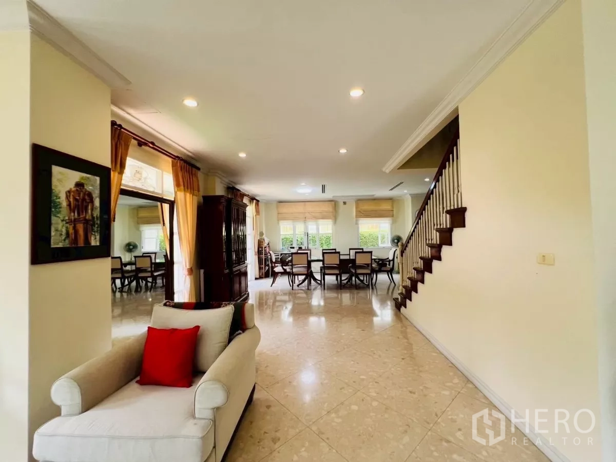 Detached House for rent in Prawet, Bangkok - Spacious ground-floor lounge and dining space with large windows and stairs.