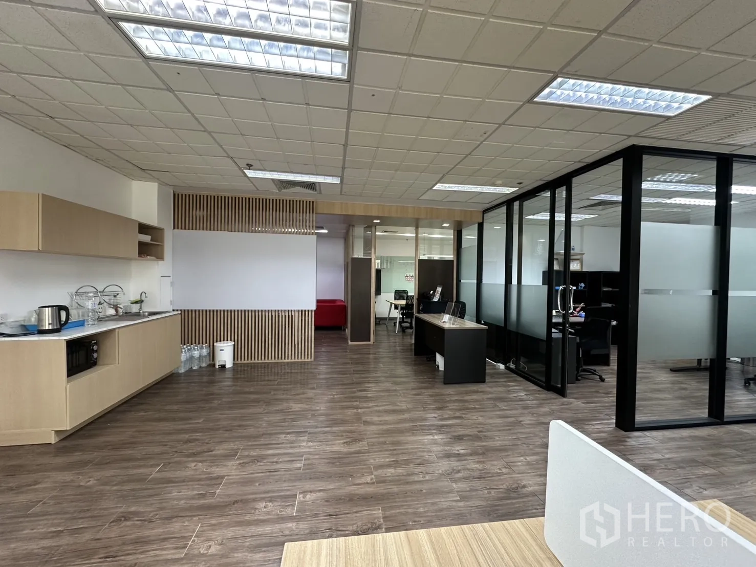 Office Space for rent - Modern office showing pantry, whiteboard wall, and glass-partitioned rooms.