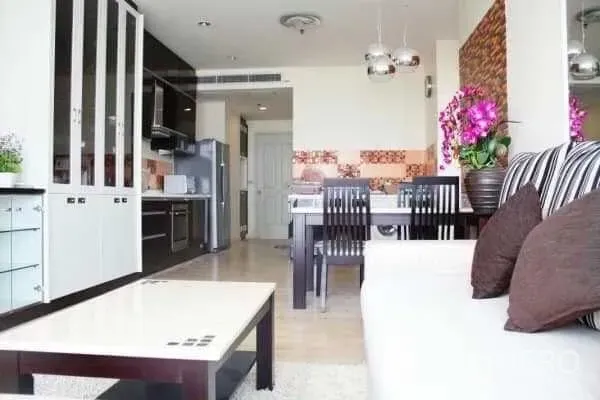 Condominium for rent in Khlong San, Bangkok - View from living area to kitchen and dining, showcasing cabinetry, pendant lights, and open layout.