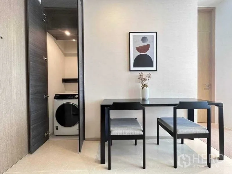 Condominium for rent in Watthana, Bangkok - Laundry closet with front-load washer beside dining table