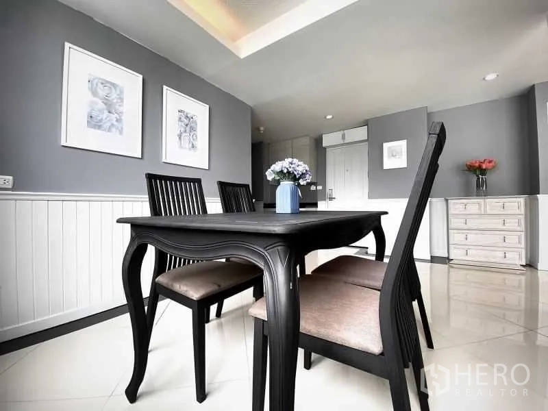 คอนโด ให้เช่าในKhlong Toei, Bangkok - มุมรับประทานอาหาร โต๊ะไม้สีเข้มสี่ที่นั่ง และกรอบรูปแต่งผนัง