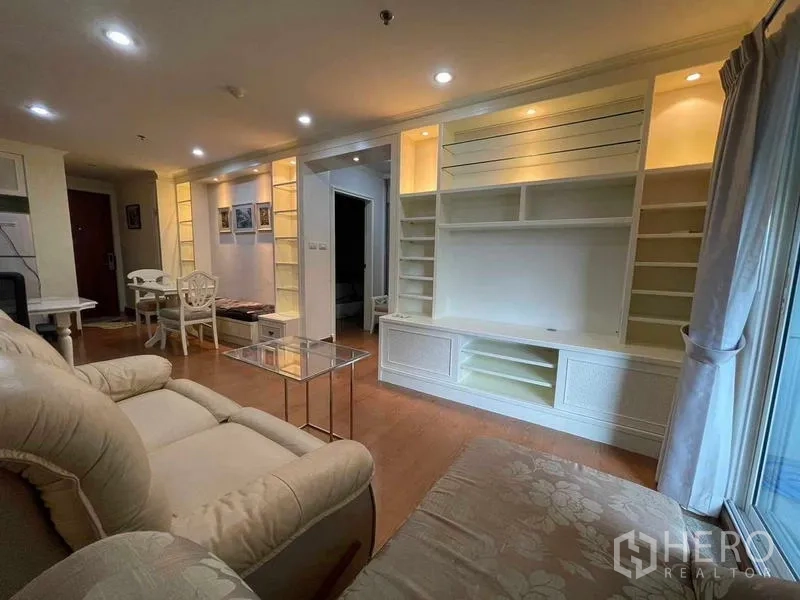 คอนโด ให้เช่า - โถงนั่งเล่นแบบโอเพ่นแปลน ชุดชั้นบิวท์อินเปิดไฟ และมุมรับประทานอาหาร