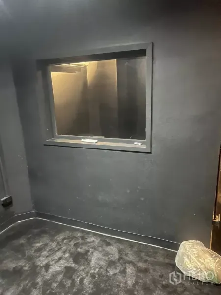 Home Office for rent in Wang Thonglang, Bangkok - Compact control room with an interior observation window set in a soundproof wall.