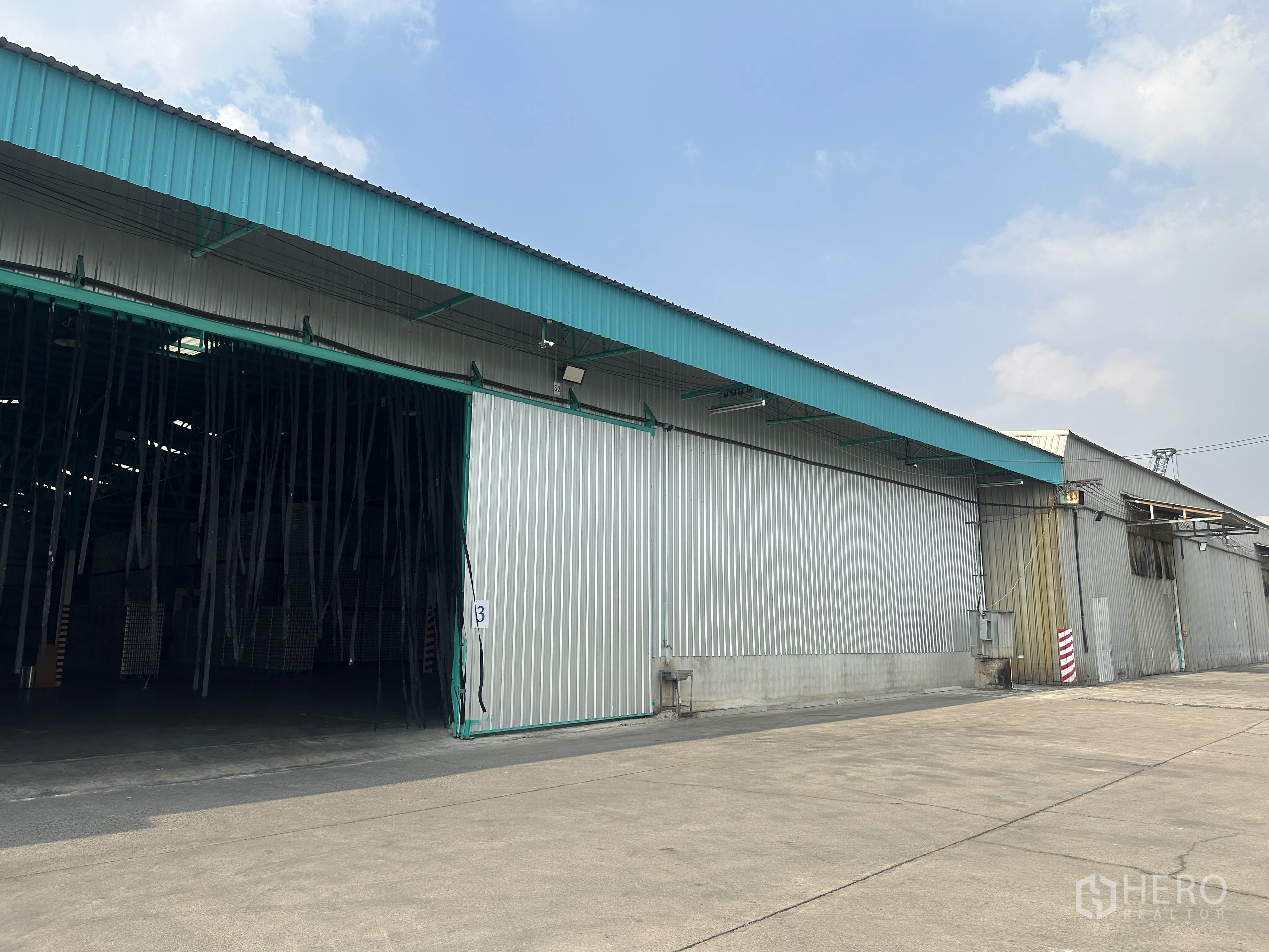 货栈 出租在Mueang Pathum Thani, Pathum Thani - 园区内仓库侧立面，卡车回转与装卸空间充裕，出入便捷。