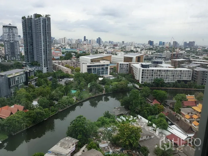 Condominium for rent in Watthana, Bangkok - High-floor city and canal view over Phra Khanong from the condo window.