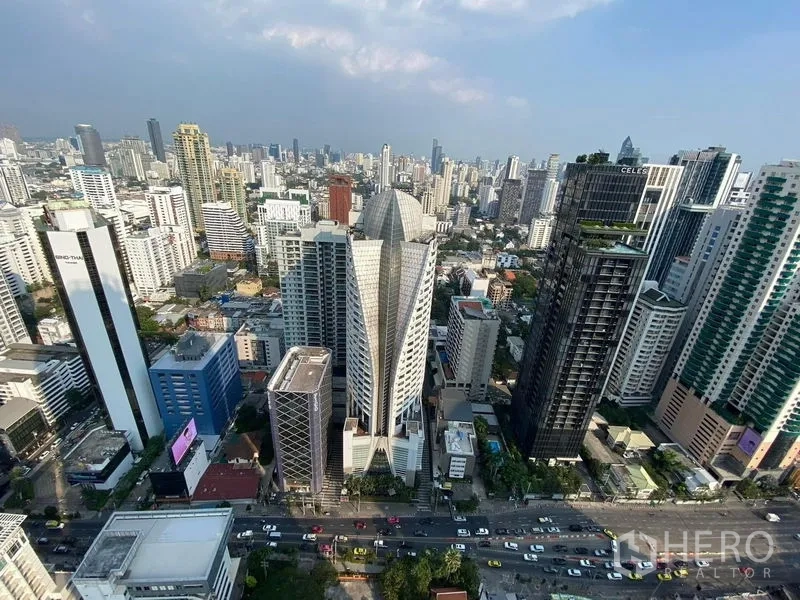 Condominium for rent in Watthana, Bangkok - High-floor city view of the Asok business district with towers and a busy road.