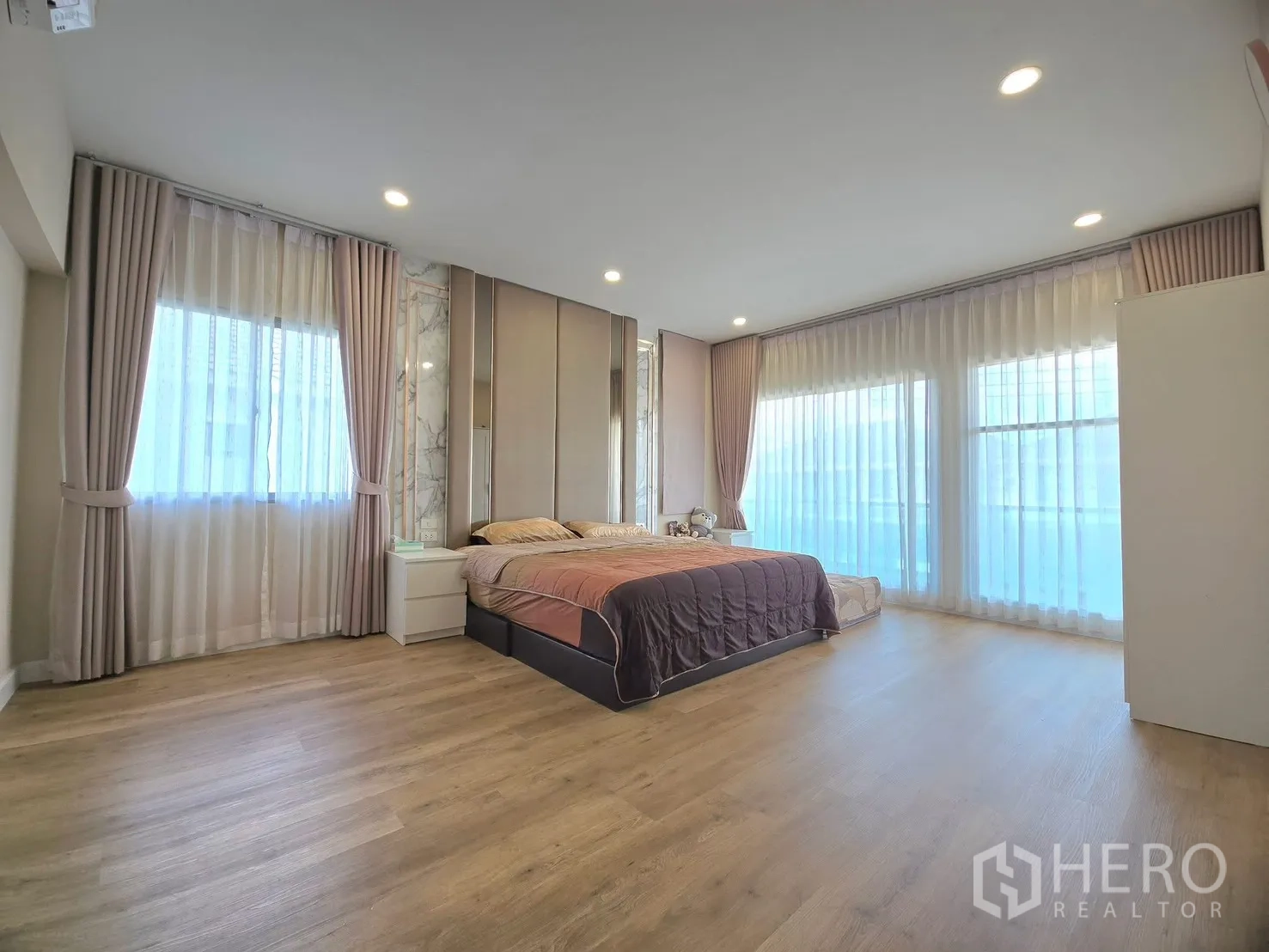 Detached House for rent in Lat Krabang, Bangkok - Large master bedroom with floor-to-ceiling windows and drapes.