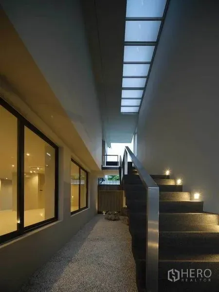Home Office for sale in Wang Thonglang, Bangkok - Covered side walkway with skylight and illuminated staircase leading to upper floor.