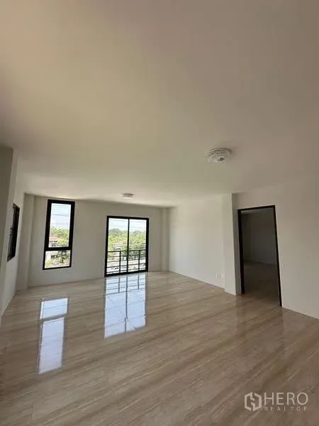 Warehouse for sale in Lat Lum Kaeo, Pathum Thani - Upper-floor office with large windows and a balcony door overlooking the site.