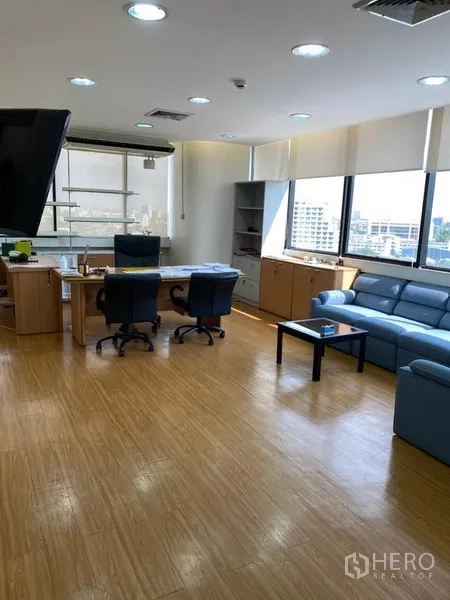 Office Space for rent in Lak Si, Bangkok - Executive office with large desk, blue leather sofa set and panoramic city views.