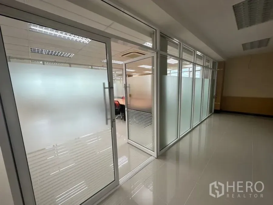 Office Space for rent in Suan Luang, Bangkok - Corridor with glass door entrance and frosted panels leading into the office suite.