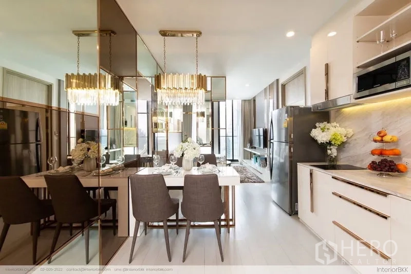 Condominium for rent in Pathum Wan, Bangkok - View from kitchen toward dining and living spaces with pendant lights and bright windows.