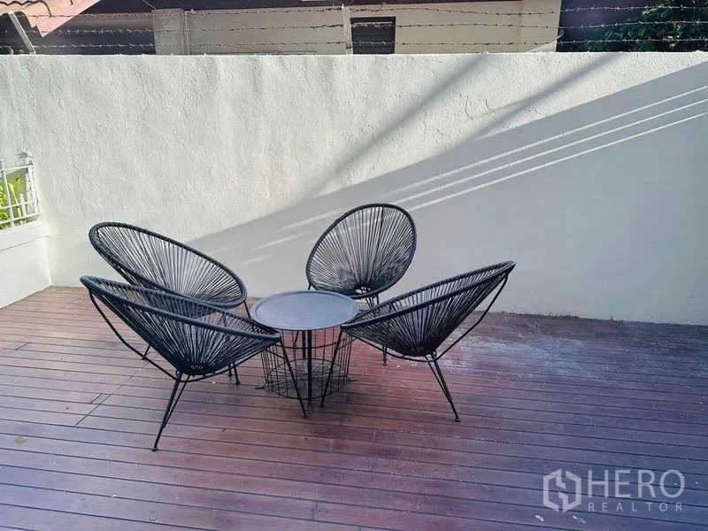 Home Office for rent in Watthana, Bangkok - Private outdoor deck with three black lounge chairs and a round table.