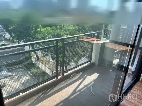 Office Space for rent in Sathon, Bangkok - Private office balcony with metal railing overlooking trees and the street below.