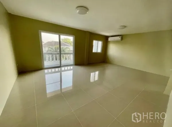Townhouse for rent - Bright living room with glossy tile floor, balcony doors and air conditioner.
