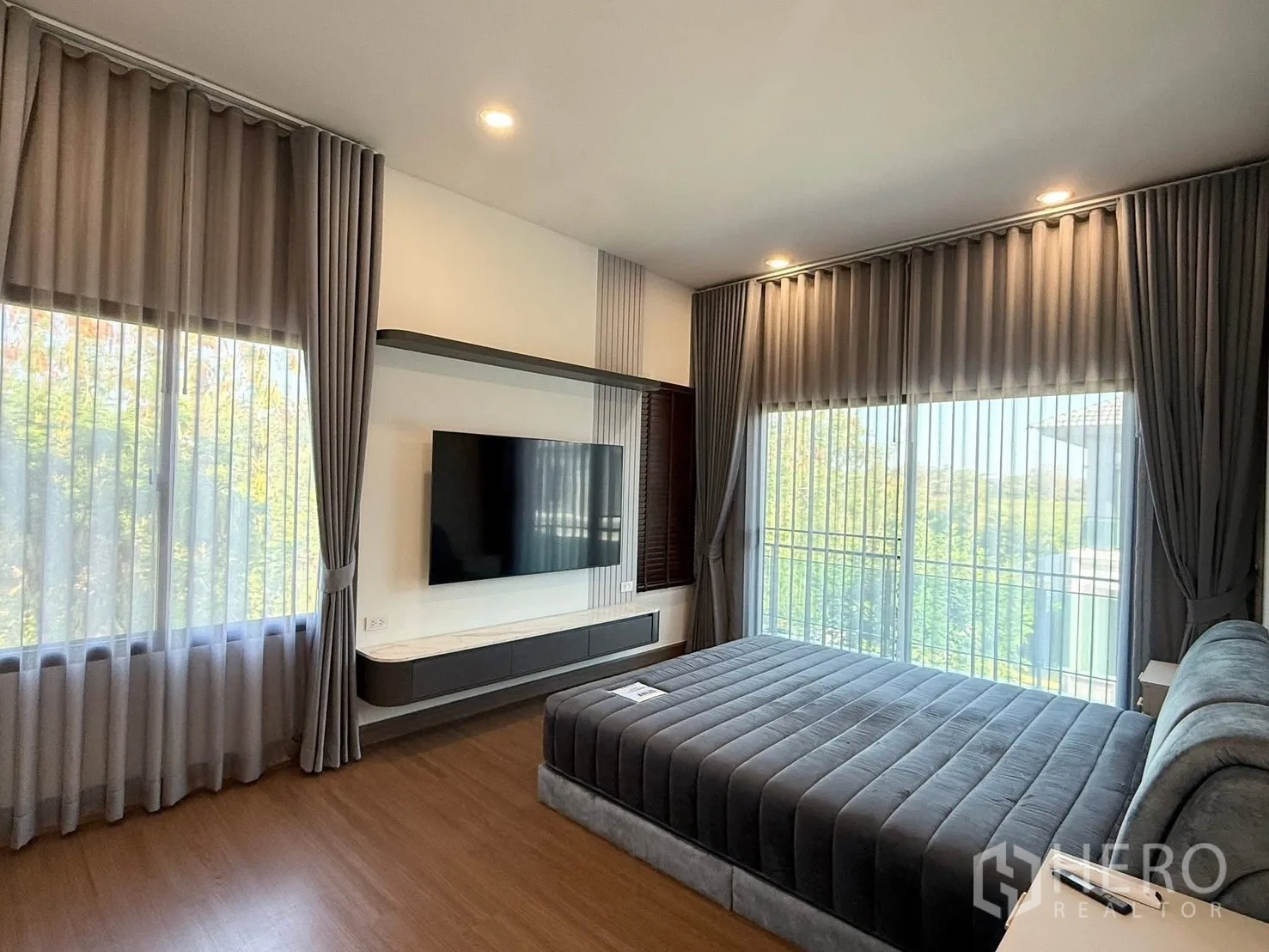 Detached House for rent in Bang Phli, Samut Prakan - Master bedroom with king bed, panoramic windows and sheer curtains.