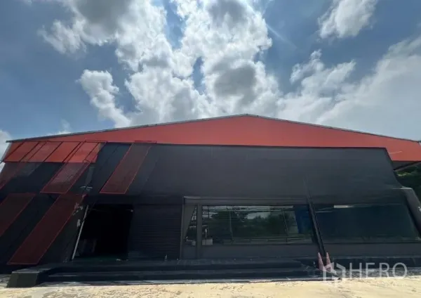 Showroom for rent in Mueang Samut Prakan, Samut Prakan - Angular black-and-red commercial building exterior with full-height glazing